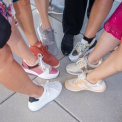 Circle of colorful sneakers worn by women